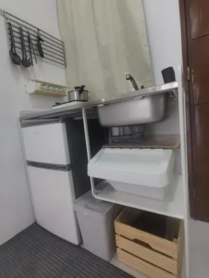 a small kitchen with a sink and a sink at Ikea inspired home with mini balcony and free parking in Cainta