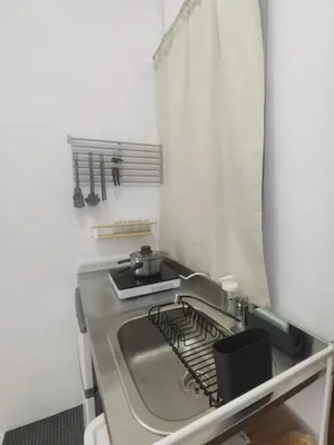a kitchen with a counter with a stove top oven at Ikea inspired home with mini balcony and free parking in Cainta