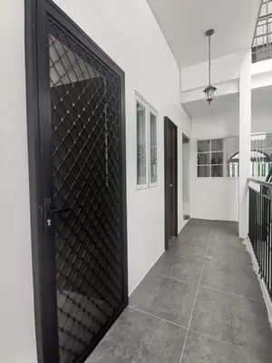a black door with a metal screen in a hallway at Ikea inspired home with mini balcony and free parking in Cainta