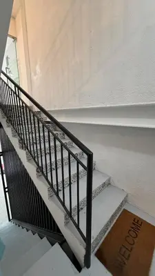 a stair case in a building with a sign on it at Ikea inspired home with mini balcony and free parking in Cainta