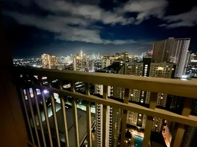 a view of the city at night from a balcony at Studio with Balcony, TV Netflix near Shaw MRT Station in Manila