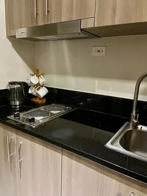 a kitchen with a sink and a counter top at Studio with Balcony, TV Netflix near Shaw MRT Station in Manila