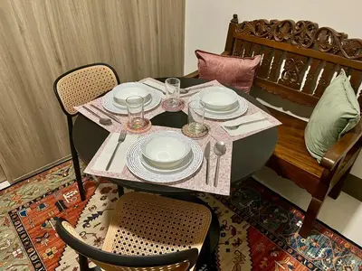 a table with plates and wine glasses on it at Studio with Balcony, TV Netflix near Shaw MRT Station in Manila