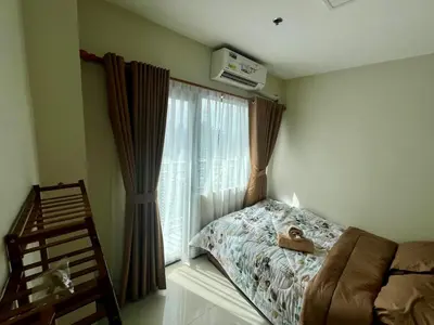 a bedroom with a bed and a window with shoes on it at Studio with Balcony, TV Netflix near Shaw MRT Station in Manila