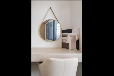 a mirror sitting on a table with a chair at EJs Crib Cozy 1BR Condo at SMDC Fame Residences in Manila