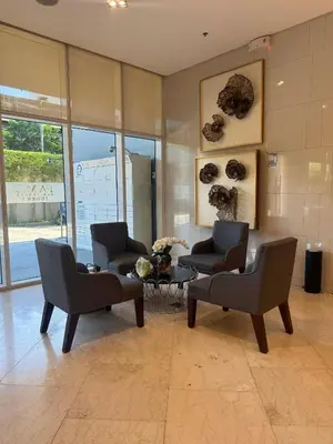 a living room with two chairs and a table at EJs Crib Cozy 1BR Condo at SMDC Fame Residences in Manila