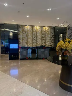 a lobby with a vase of flowers on a table at EJs Crib Cozy 1BR Condo at SMDC Fame Residences in Manila
