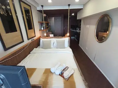 a room with two beds and a mirror at Benedict's Staycation in Manila