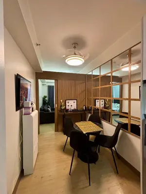 a living room with a table and chairs at Casa Kanlungan at Spring Residences Tower 3 in Manila