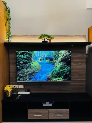a flat screen tv sitting on top of a entertainment center at Melscape Lush Residence 1BR Unit in Sampong