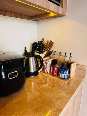 a kitchen counter with a coffee pot and utensils at Luxe 1BR Panorama Suite at Novotel Aqua in Manila