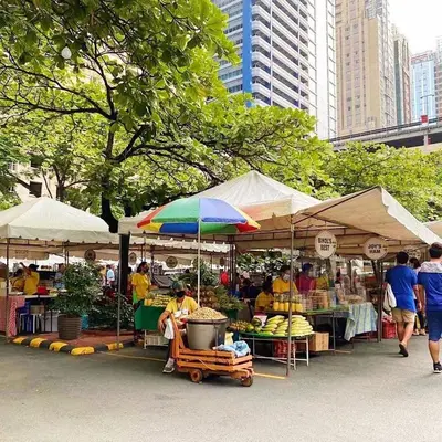 a market with umbrellas and fruits and vegetables at Melscape Lush Residence 1BR Unit in Manila