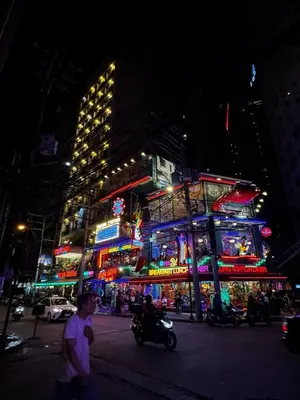 a busy city street at night with neon signs at Melscape Lush Residence 1BR Unit in Manila