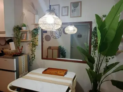 a room with a mirror and a table and a mirror at Raku Home - Urban Resort Living in Manila