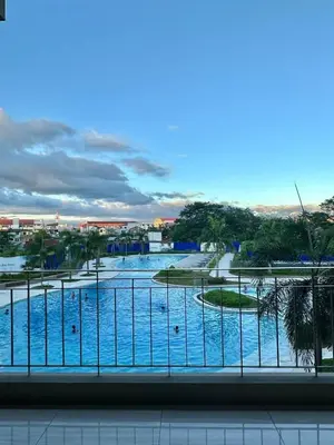 a view of a swimming pool from a balcony at Raku Home - Urban Resort Living in Manila