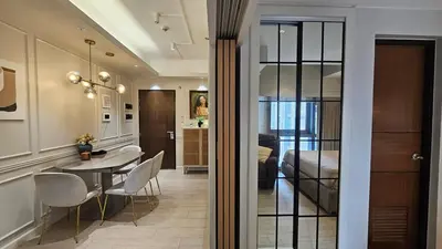 a room with a dining table and a bedroom at One Bedroom Premier at Eastwood Global Plaza Luxury Residences in Manila