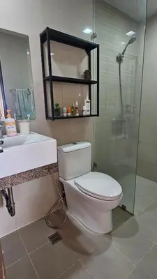 a bathroom with a toilet and a sink and a shower at One Bedroom Premier at Eastwood Global Plaza Luxury Residences in Manila