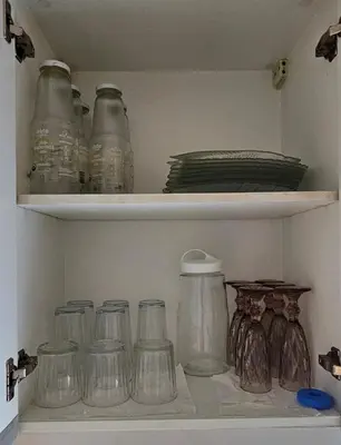 a shelf filled with glass jars and other items at One Bedroom Premier at Eastwood Global Plaza Luxury Residences in Manila