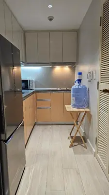 a kitchen with a table with a bag on it at One Bedroom Premier at Eastwood Global Plaza Luxury Residences in Manila