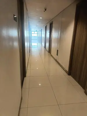 an empty hallway in a office building with a long corridor at Sea Residences peya in Manila