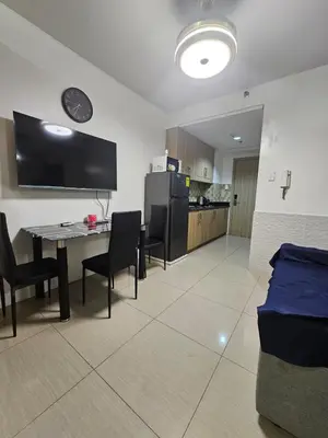 a room with a table and chairs and a kitchen at Shore Recidences Mall Of Asia Chullen in Manila