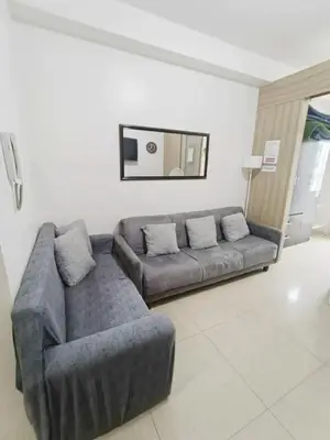 a living room with a couch and a couch and a chair at Shore Recidences Mall Of Asia Chullen in Manila