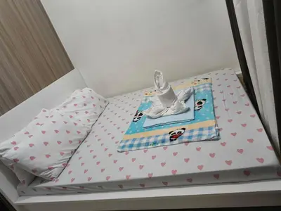 a small bed with a figurine on top of it at Shore Recidences Mall Of Asia Chullen in Manila