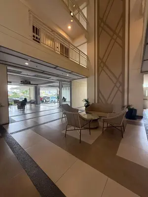 a lobby with chairs and a table in a building at Cozy Home with a great view in Manila