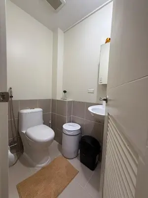 a bathroom with a toilet and a sink at Cozy Home with a great view in Manila