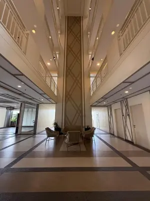 a lobby with chairs and tables in a building at Cozy Home with a great view in Manila