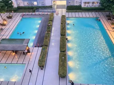 an overhead view of two large swimming pools at Light Residences by SMDC Boni MRT EDSA in Manila