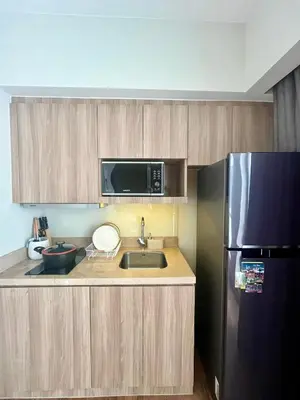 a kitchen with a sink and a refrigerator at Hotel Residences at Acqua in Manila