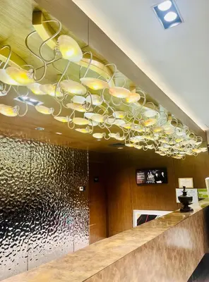 a chandelier hanging from the ceiling in a lobby at Hotel Residences at Acqua in Manila