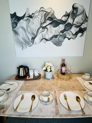 a table with plates and utensils on it at Hotel Residences at Acqua in Manila