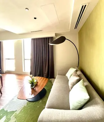 a living room with a couch and a table at Hotel Residences at Acqua in Manila