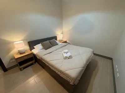 a bedroom with a bed with two lamps on it at Luxury-Styled 2BR Uptown T2 Parksuites BGC in Manila