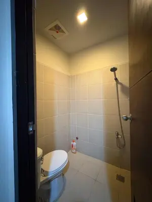 a bathroom with a toilet and a shower at Luxury-Styled 2BR Uptown T2 Parksuites BGC in Manila
