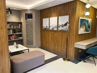 a living room with a couch and a table at Sofi Staycation- Aurora Escalades in Manila