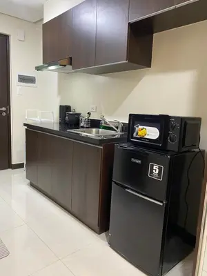 a kitchen with a sink and a counter top at Sofi Staycation- Aurora Escalades in Manila