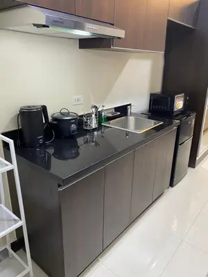 a kitchen with a sink and a counter top at Sofi Staycation- Aurora Escalades in Manila