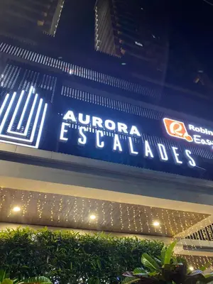 a sign on the side of a building at Sofi Staycation- Aurora Escalades in Manila
