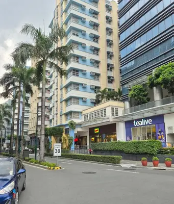 a car parked in front of a large building at Jacob's Place Near Manila Airport in Manila
