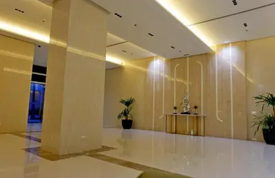 a lobby with two potted plants in a building at Jacob's Place Near Manila Airport in Manila