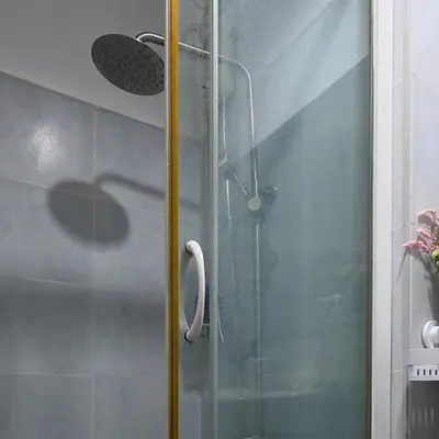 a shower with a glass door in a bathroom at MOA Staycation - Sea Residences - Tower C in Manila