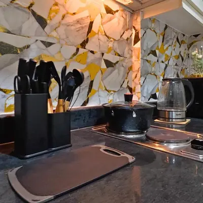 a kitchen counter with utensils on a counter top at MOA Staycation - Sea Residences - Tower C in Manila