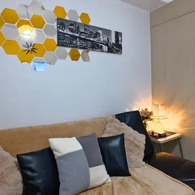 a living room with a couch and a picture on the wall at MOA Staycation - Sea Residences - Tower C in Manila