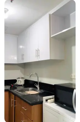 a kitchen with white cabinets and a sink at NAIA Terminal 3 Kaydren Airport Suite I Walk to Casino & Mall l 9-mins to Naia l Modern Stay 1 Bedroom in Manila