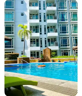 a swimming pool in front of a building at NAIA Terminal 3 Kaydren Airport Suite I Walk to Casino & Mall l 9-mins to Naia l Modern Stay 1 Bedroom in Manila