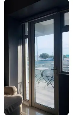 a sliding glass door with a view of a patio at NAIA Terminal 3 Kaydren Airport Suite I Walk to Casino & Mall l 9-mins to Naia l Modern Stay 1 Bedroom in Manila