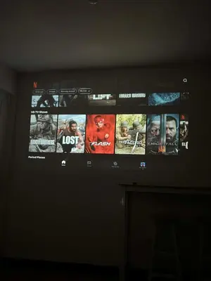 a television screen with many movies on it at Jade Condo Netflix Wifi Karaoke with Cinema Projector in Imus